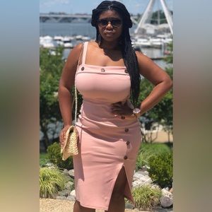 Pink bodycon dress with thigh slit and tortoise colored button detail